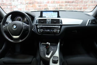 BMW 1 Series 118i Executive Sport Line Automaat 5 deurs / Navigatie Professional / LED / Trekhaak / Climate Control / 17 Inch / Bluetooth / Sportstoelen / Parkeersensoren / Lichtpakket / Cruise Control / Stoelverwarming / Neerklapbare Achterbank / 16